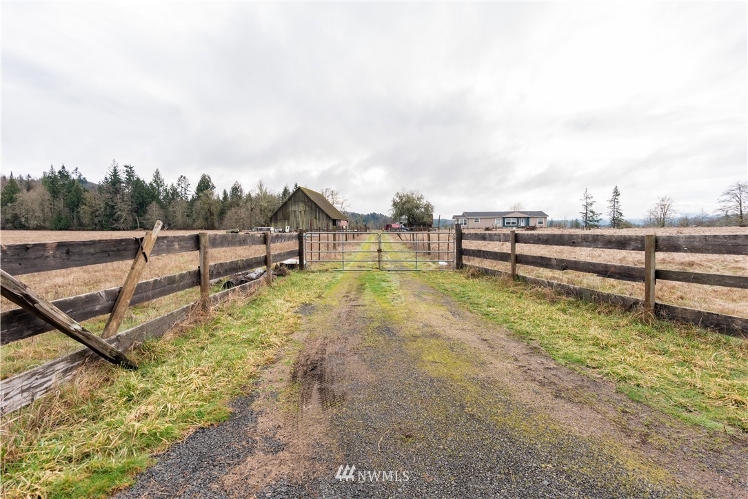 168 Katula Road Chehalis, WA 98532 - Photo 16 of 40 a view of a swimming pool with a bench and wooden fence
