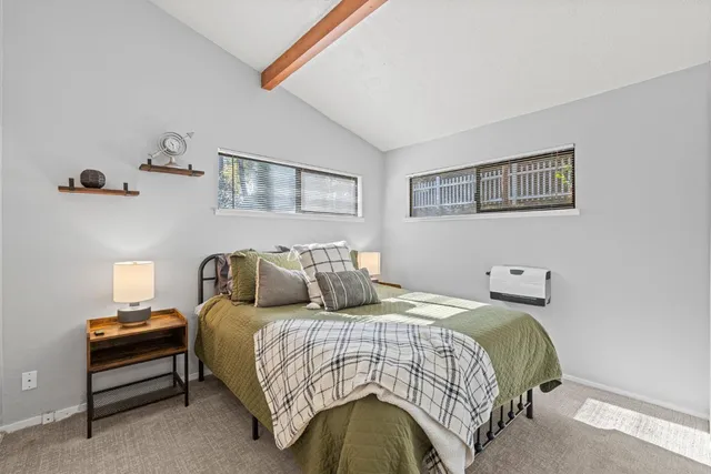 a view of a bedroom with bed and furniture