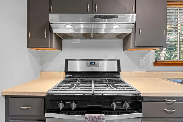 a stove top oven sitting inside of a kitchen