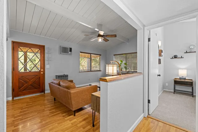 a living room with furniture a window and a flat screen tv