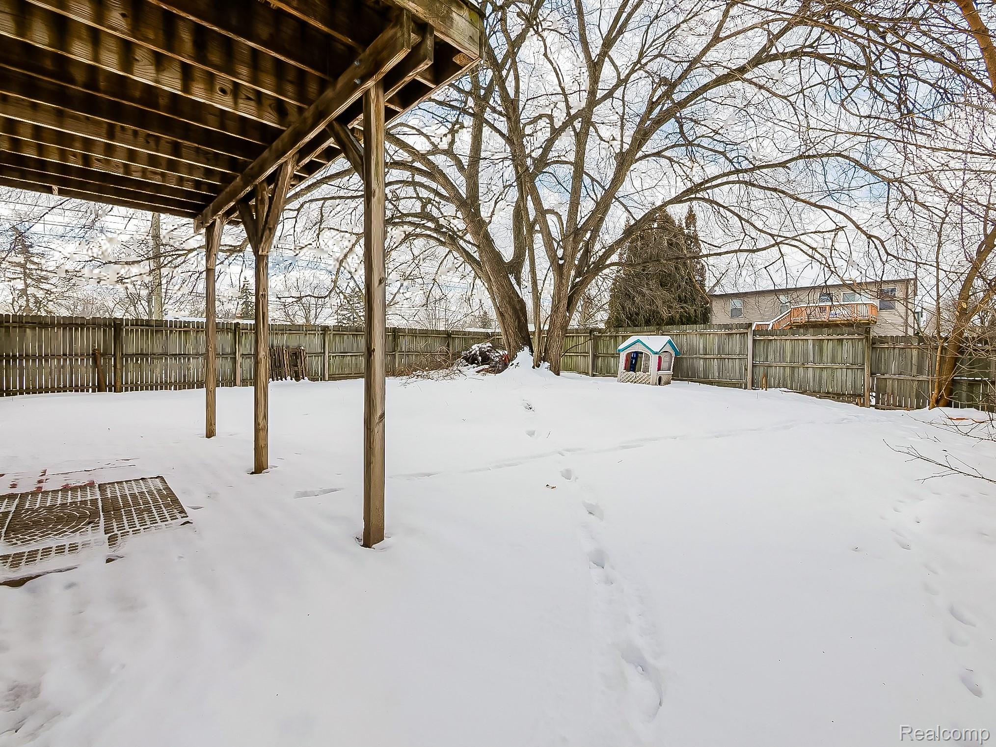 34460 Van Born Road Wayne, MI 48184 - Photo 26 of 31 Yard layered in snow with a fenced backyard