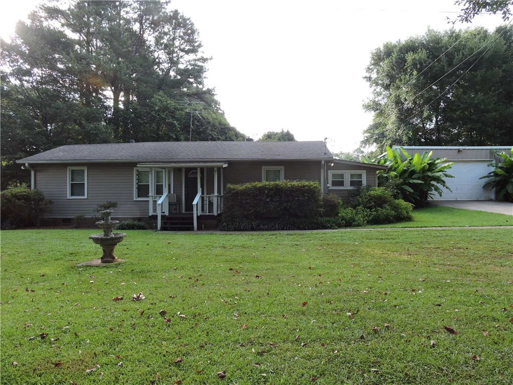 1901 Hattons Ford Road Townville, SC 29689 - Photo 3 of 33 A classic ranch home offers a welcoming front porch and an expansive lawn with mature trees.
