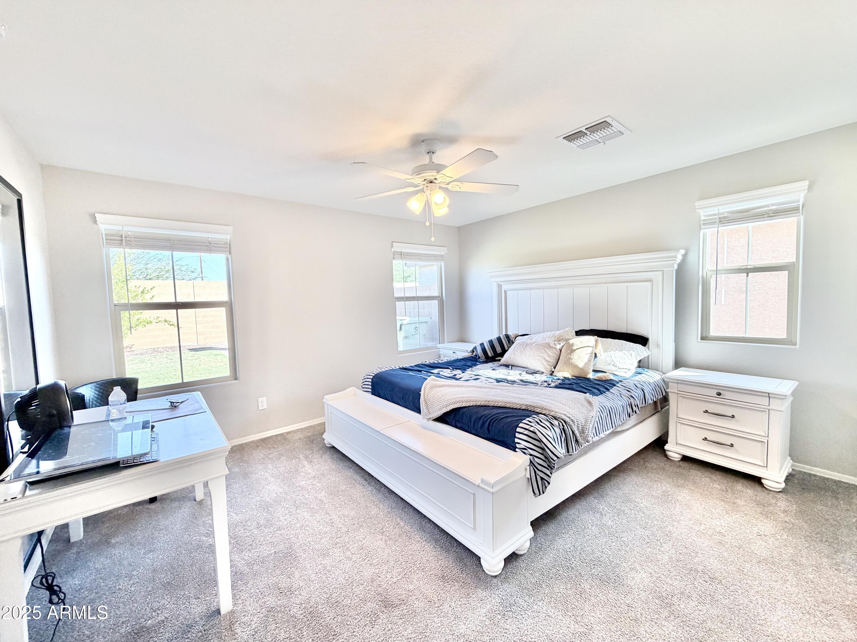 8208 West Sands Road Glendale, AZ 85303 - Photo 11 of 27 a bedroom with a bed and a couch