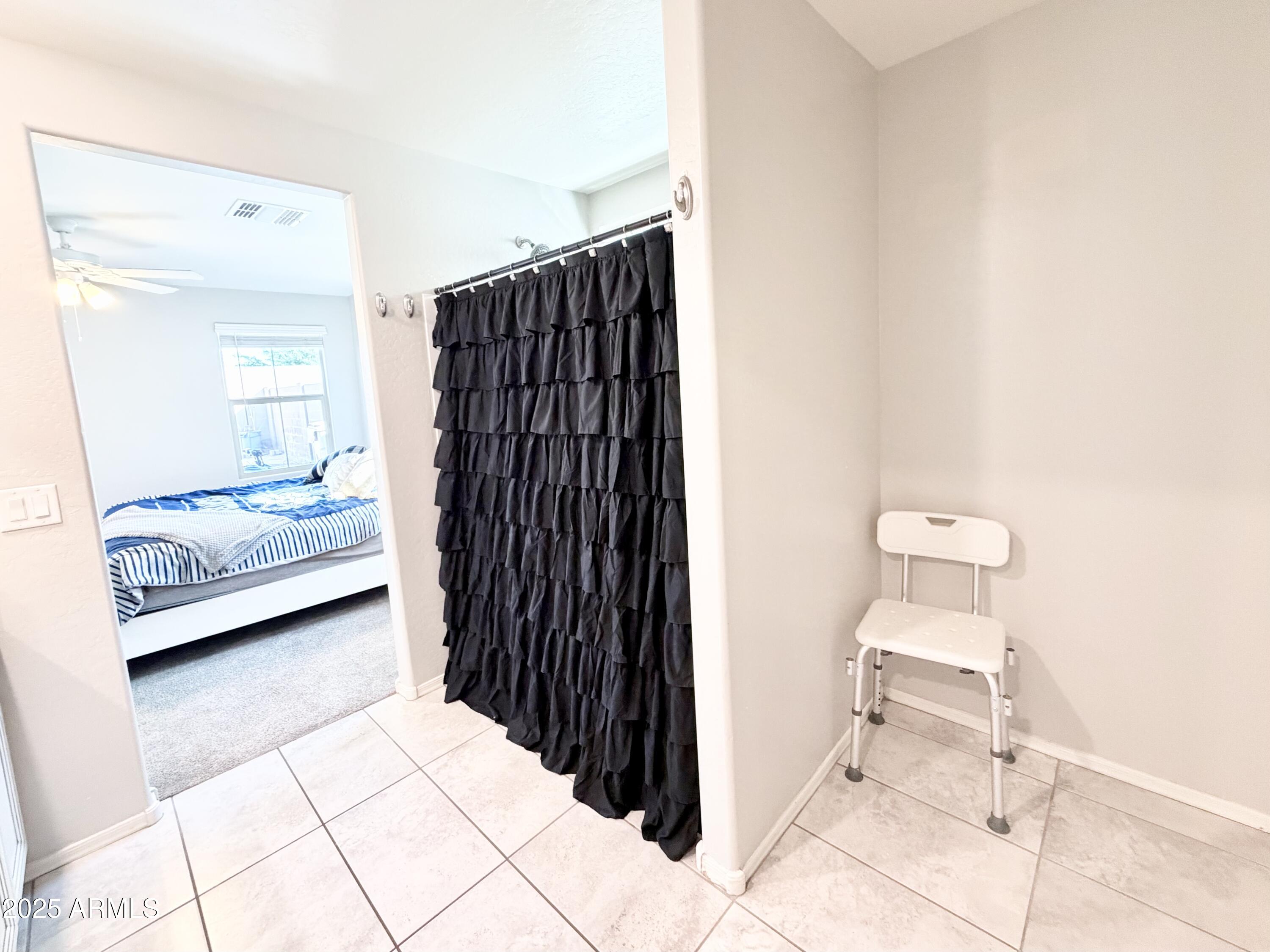 8208 West Sands Road Glendale, AZ 85303 - Photo 16 of 27 a bedroom with a bed and a chair