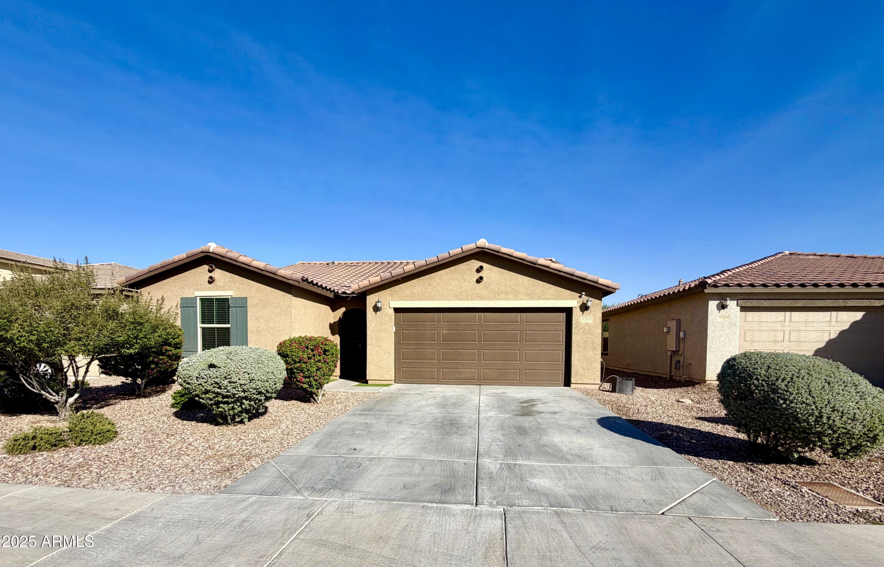 8208 West Sands Road Glendale, AZ 85303 - Photo 2 of 27 a front view of a house with a yard and garage