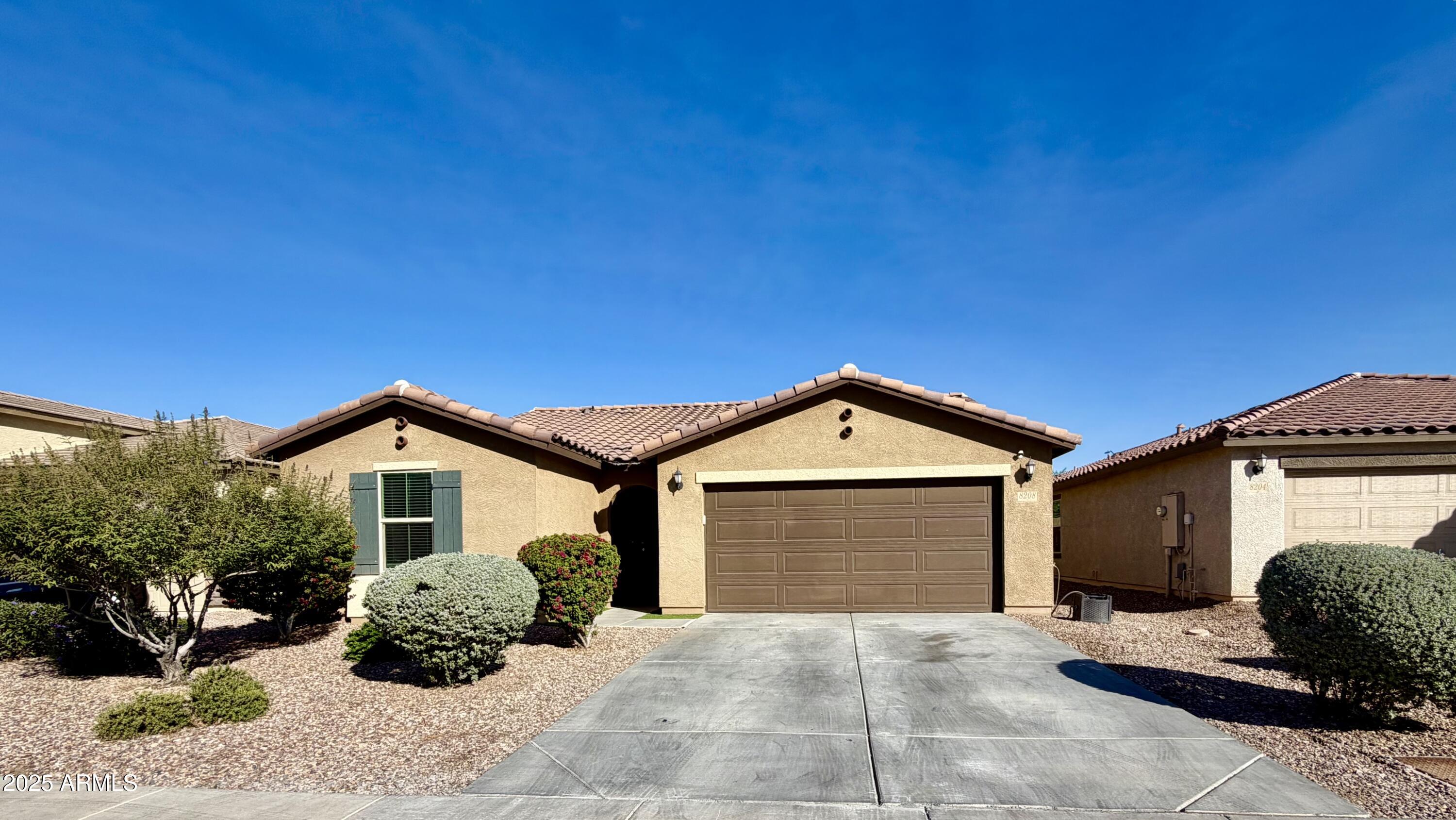 8208 West Sands Road Glendale, AZ 85303 - Photo 27 of 27 a front view of a house with a yard and garage