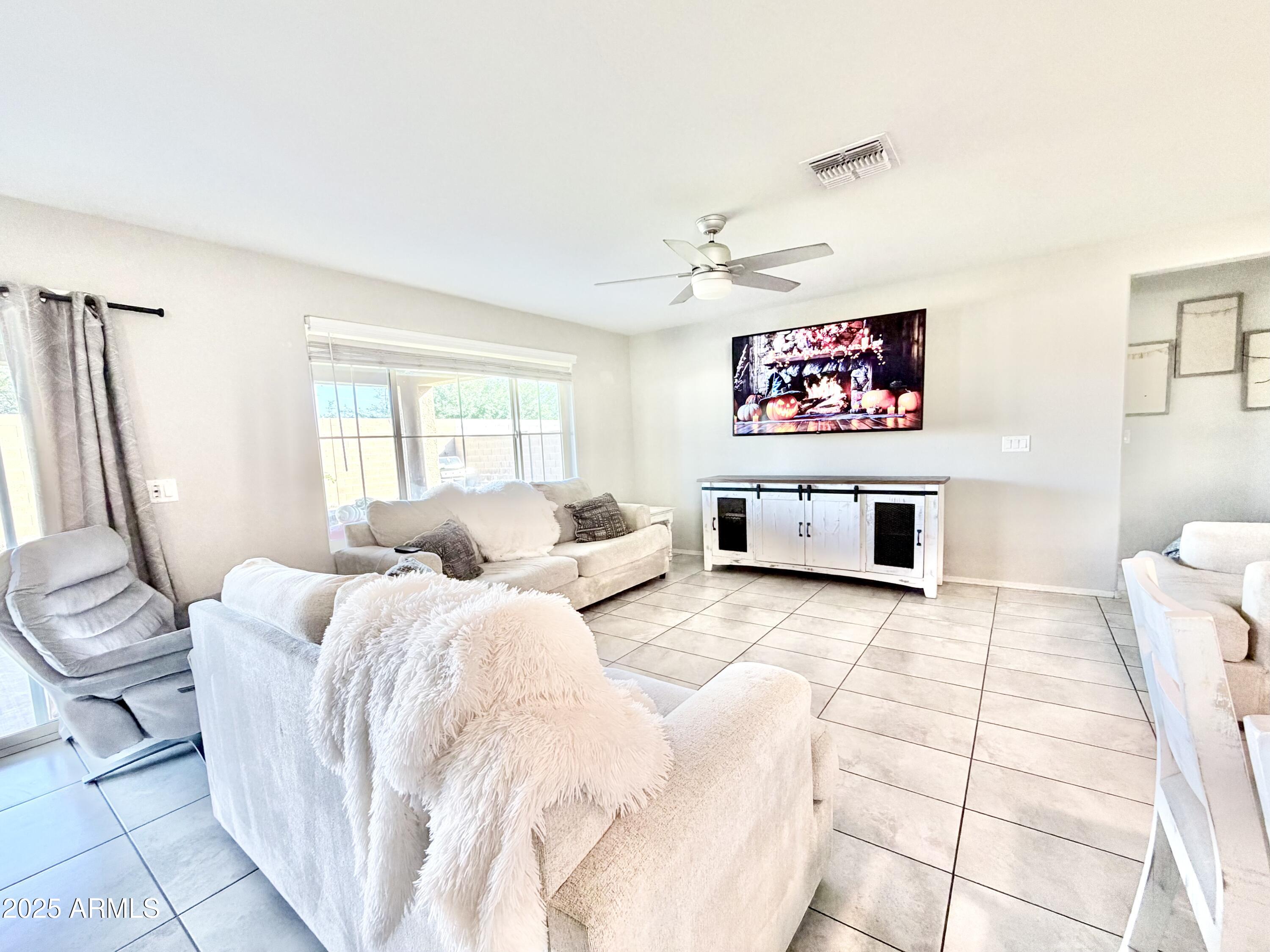 8208 West Sands Road Glendale, AZ 85303 - Photo 6 of 27 a spacious bedroom with a bed and a couch