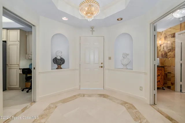 a bedroom with furniture and a large window