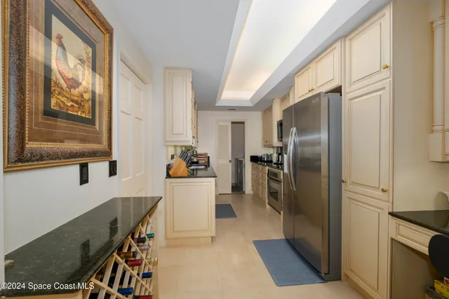 a kitchen with granite countertop stainless steel appliances a sink a stove and cabinets