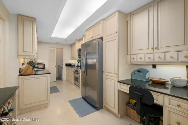a kitchen with stainless steel appliances granite countertop a sink and cabinets