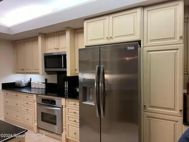 a dining room with furniture a chandelier and window