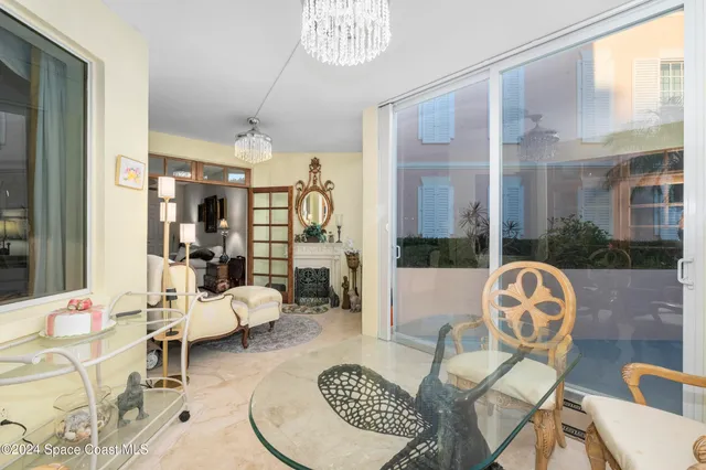a living room with furniture a mirror and a fireplace
