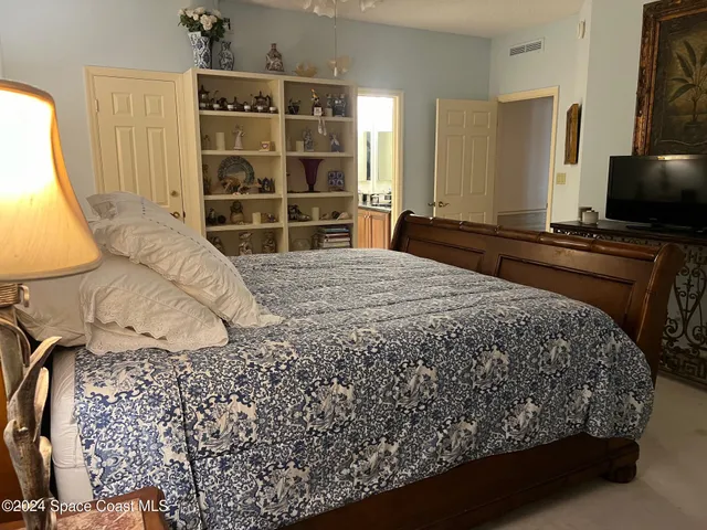a bedroom with a bed and a dresser