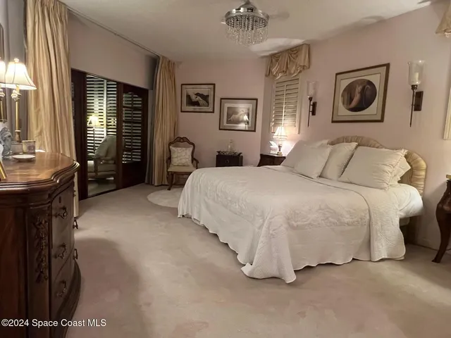 a bedroom with a bed and lamp with window