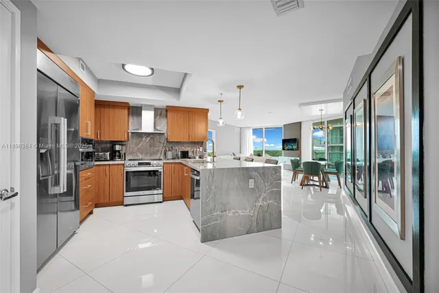 a kitchen with stainless steel appliances a refrigerator a stove top oven and a sink