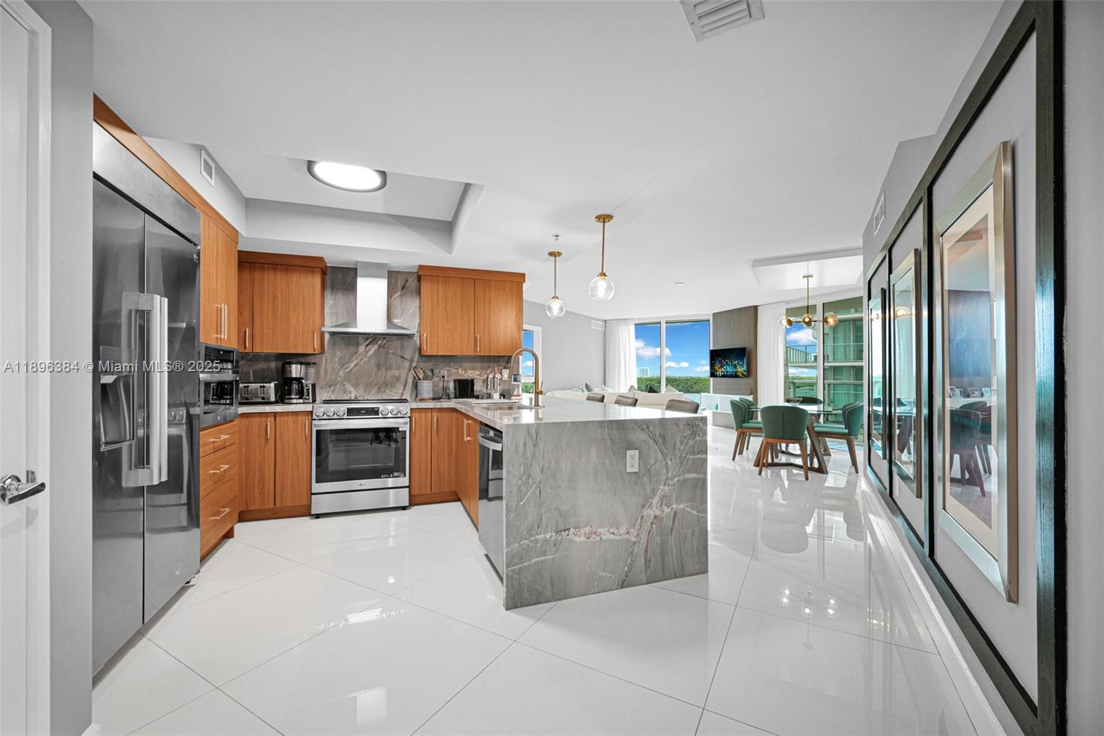a kitchen with stainless steel appliances a refrigerator a stove top oven and a sink