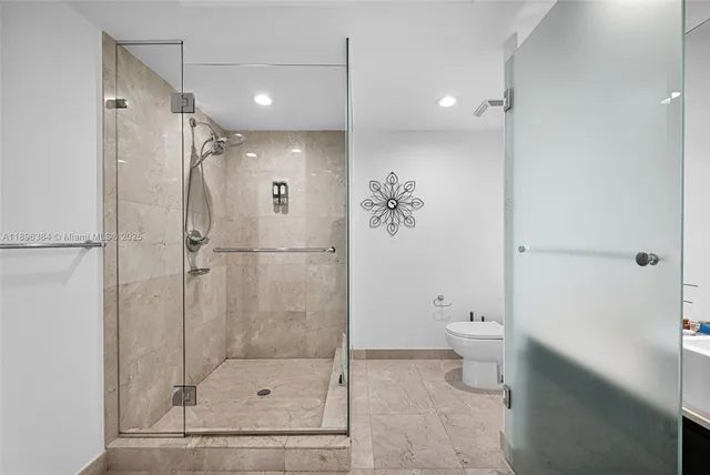 a bathroom with a shower a toilet and sink