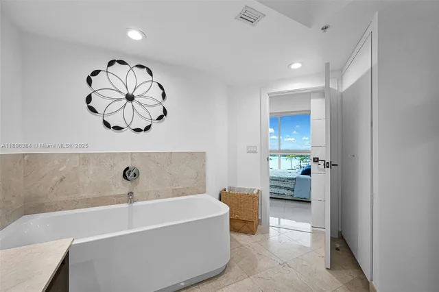 a bathroom with a bathtub and shower