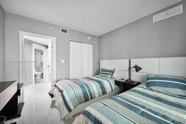 a bedroom with two beds and painted walls