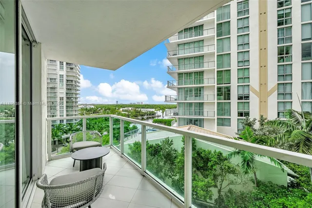 a view of a balcony with chair and wooden floor