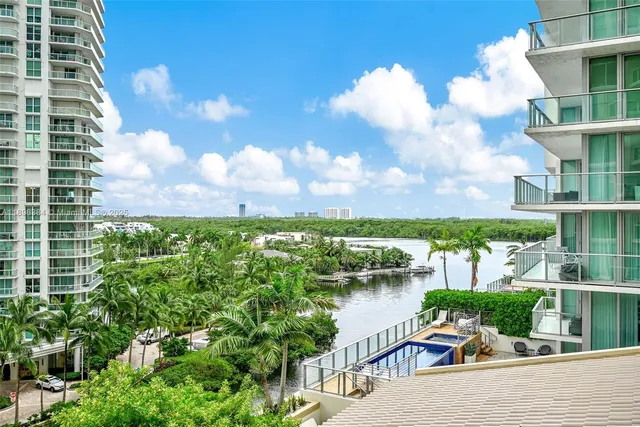 a balcony with furniture and a lake view