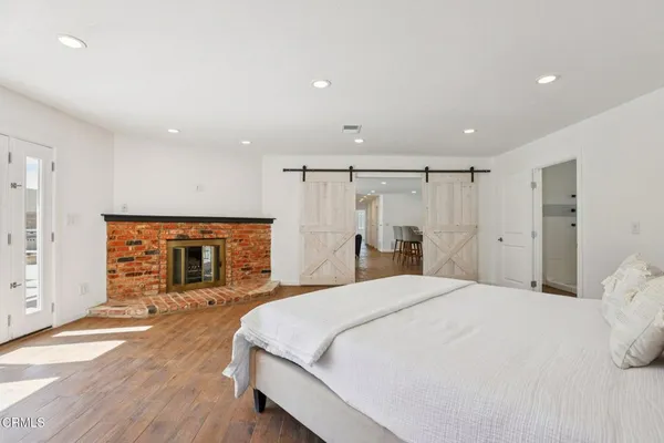 a spacious bedroom with a bed and a large mirror