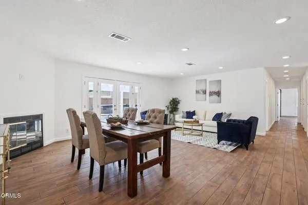 a view of a dining room with furniture and wooden floor