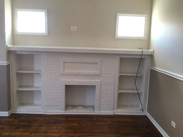 a room with a fireplace and a window
