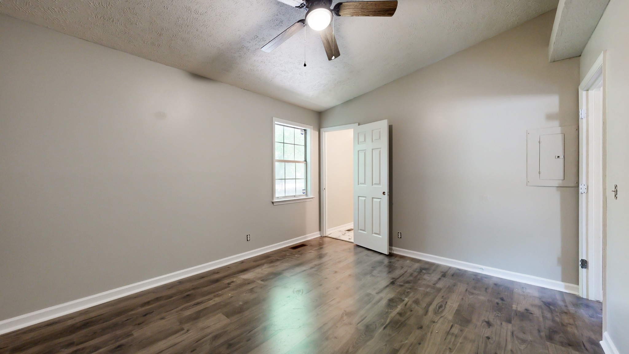1320 Rice Hill Circle Antioch, TN 37013 - Photo 8 of 26 an empty room with wooden floor chandelier fan and windows