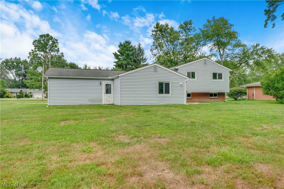 646 Ledge Road Macedonia, OH 44056 - Photo 25 of 28 Spacious rear yard with a two-story residence featuring light-colored siding and a partial brick foundation