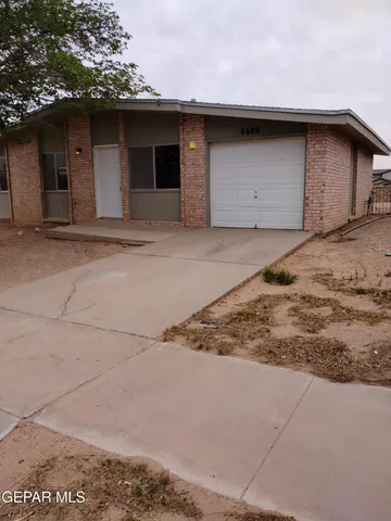 a front view of a house with garage