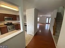 a view of a hallway to a kitchen