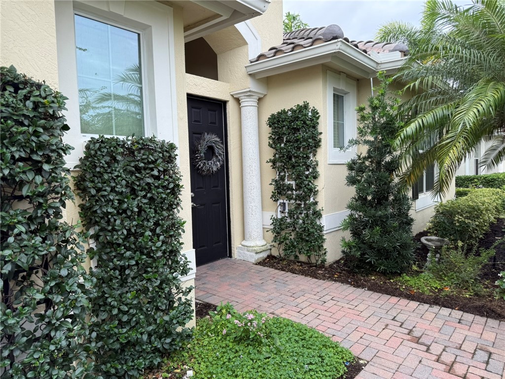4253 Diamond Square Vero Beach, FL 32967 - Photo 1 of 22 a front view of a house with garden