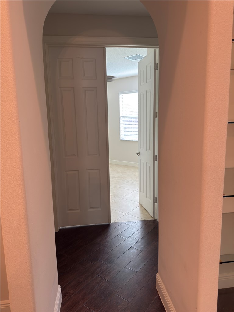 4253 Diamond Square Vero Beach, FL 32967 - Photo 12 of 22 a view of a hallway with wooden floor