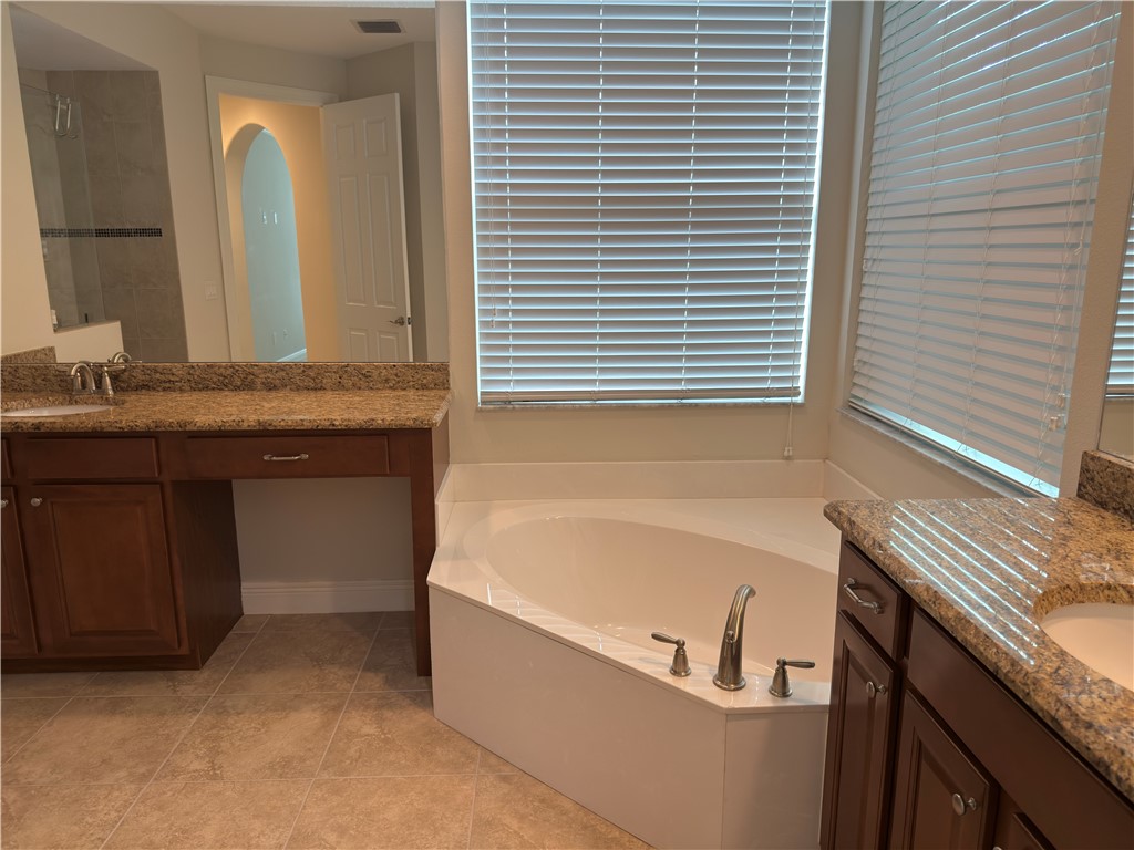 4253 Diamond Square Vero Beach, FL 32967 - Photo 15 of 22 a bathroom with a granite countertop sink and a bathtub