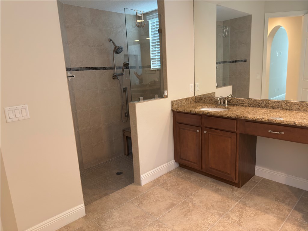 4253 Diamond Square Vero Beach, FL 32967 - Photo 16 of 22 a bathroom with a granite countertop sink and a mirror