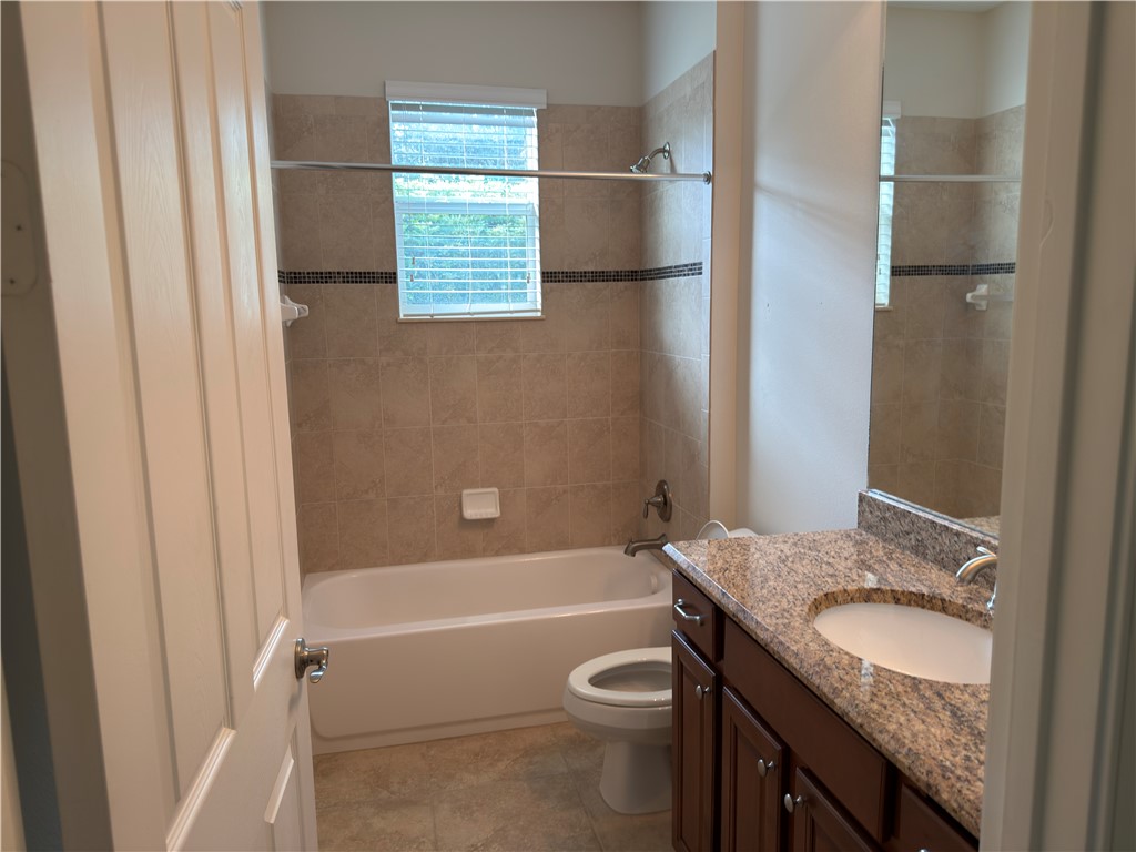 4253 Diamond Square Vero Beach, FL 32967 - Photo 18 of 22 a bathroom with a granite countertop sink toilet and shower