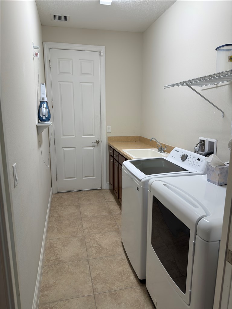 4253 Diamond Square Vero Beach, FL 32967 - Photo 22 of 22 a utility room with dryer and washer