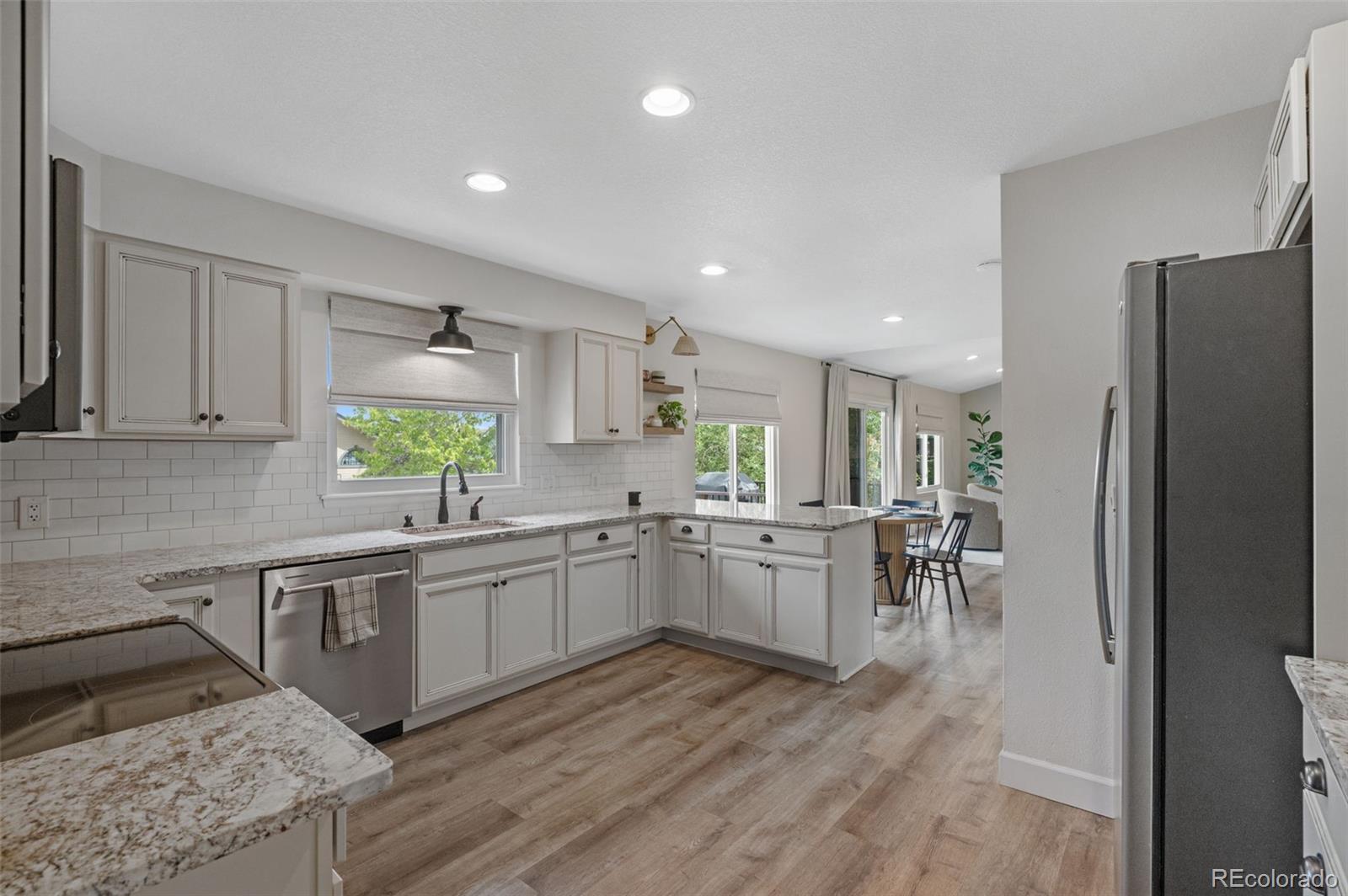 9272 South Crestmore Way Highlands Ranch, CO 80126 - Photo 7 of 46 a kitchen with lots of counter top space and stainless steel appliances