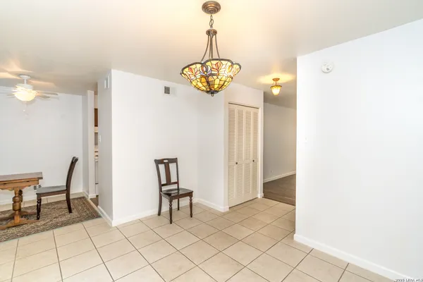 a view of a bedroom with wooden floor and cabinet