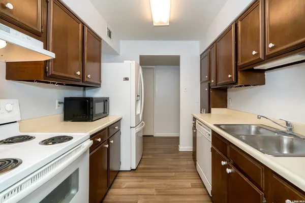 a kitchen with a sink a stove and cabinets