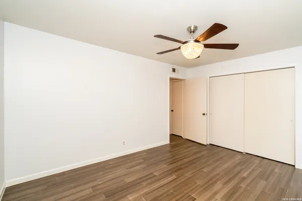a view of a room with wooden floor