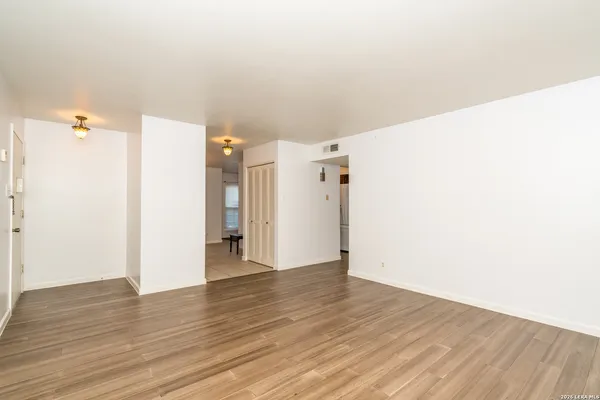 a view of a room with wooden floor