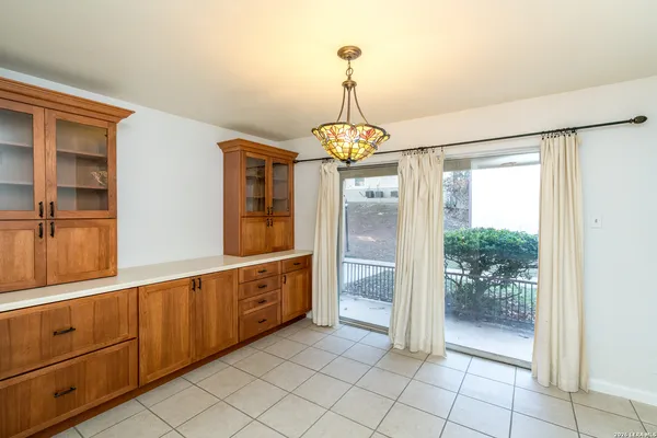 a dining room with furniture a chandelier and a rug