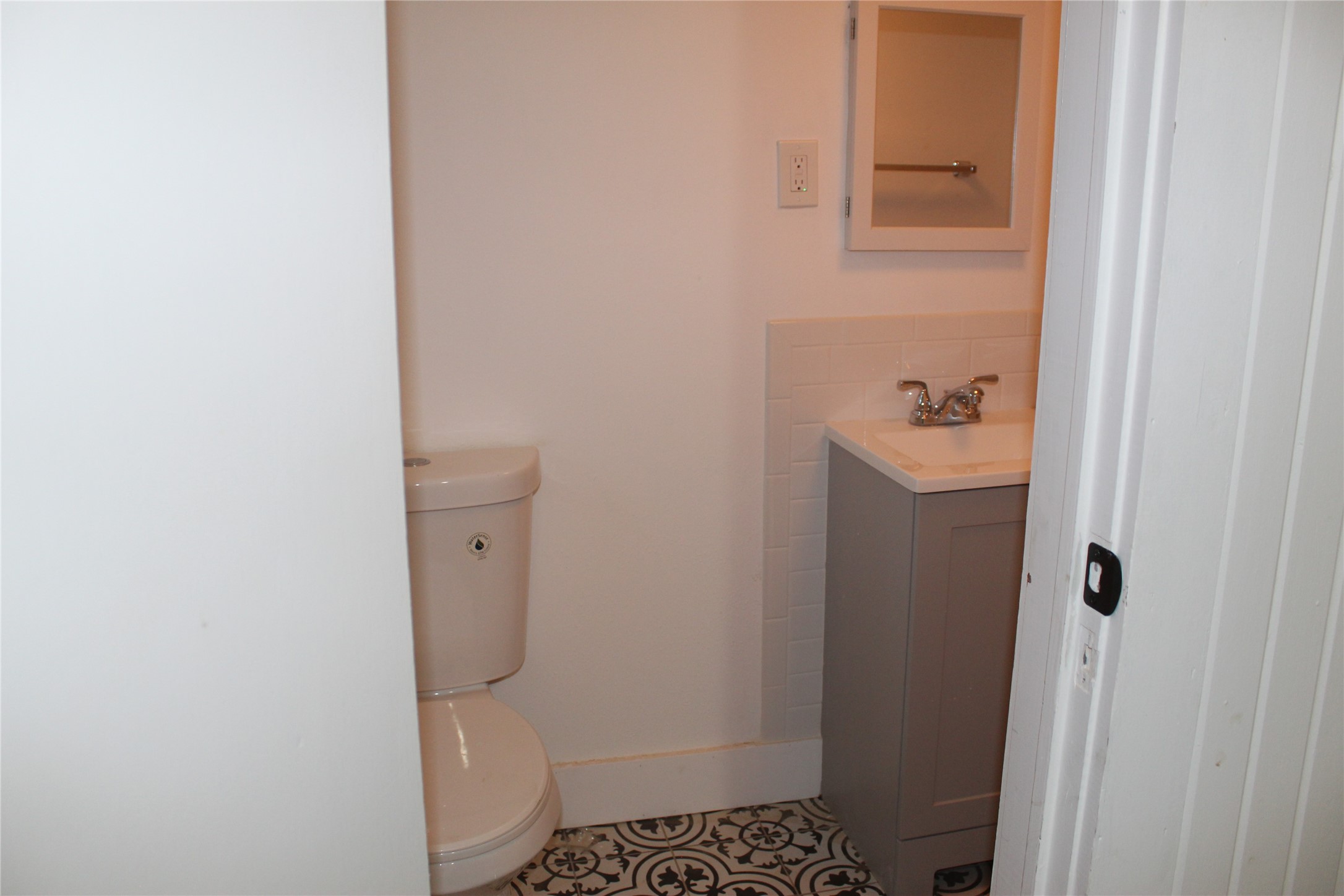 2713 Cochran Street Houston, TX 77009 - Photo 20 of 28 a bathroom with a granite countertop toilet and a sink