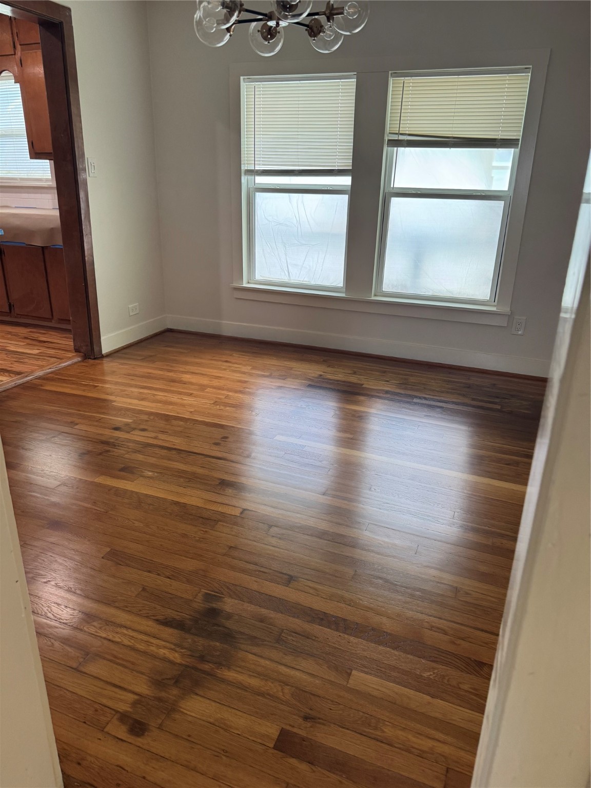 2713 Cochran Street Houston, TX 77009 - Photo 23 of 28 an empty room with wooden floor and windows