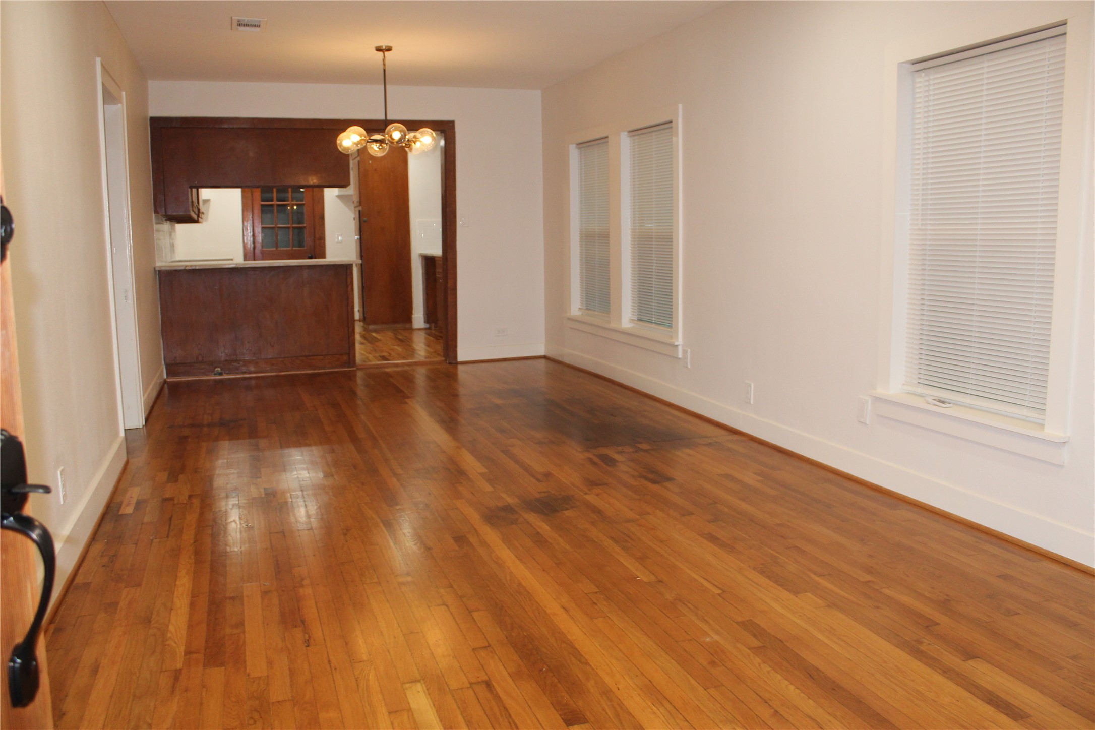 2713 Cochran Street Houston, TX 77009 - Photo 7 of 28 wooden floor in an empty room with a window