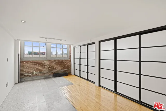 a bathroom with a tub shower vanity and a sink