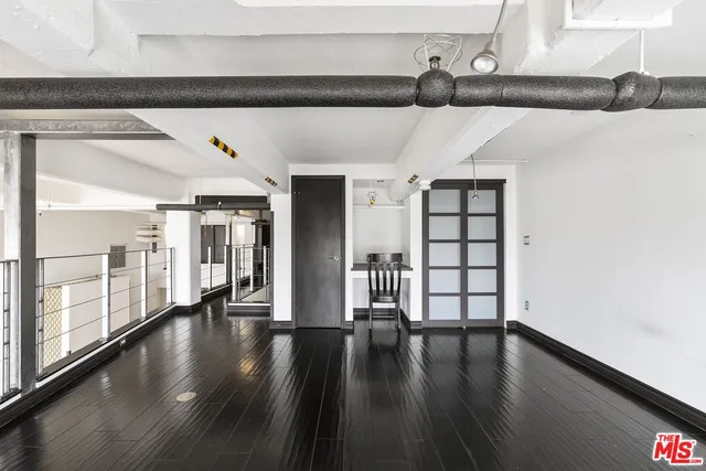a view of wooden floor and chairs in a room