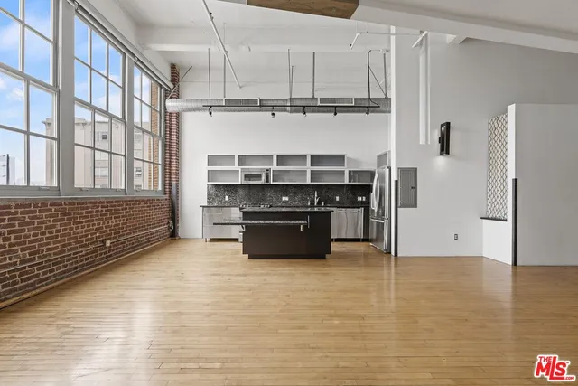 a kitchen with stainless steel appliances a refrigerator and a stove